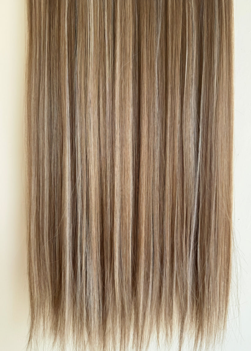 Blonde hair extensions on a white background